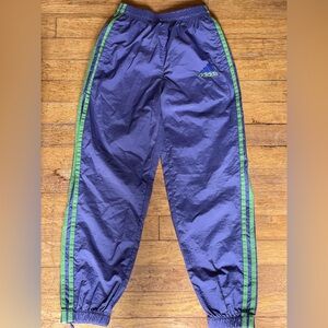 Girls’ Adidas purple with green trim track pants. Zippered at the ankle.